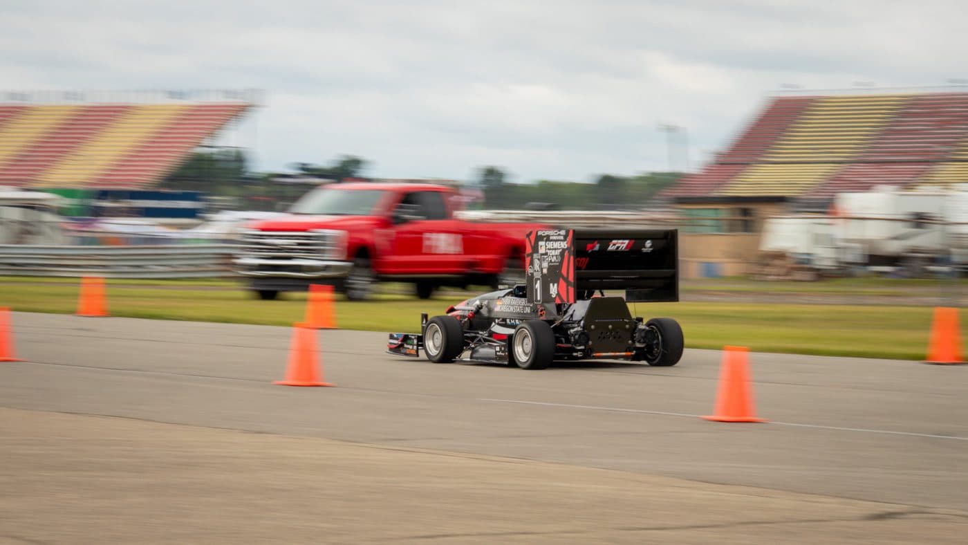 The car on course between the cones during the autocross event.