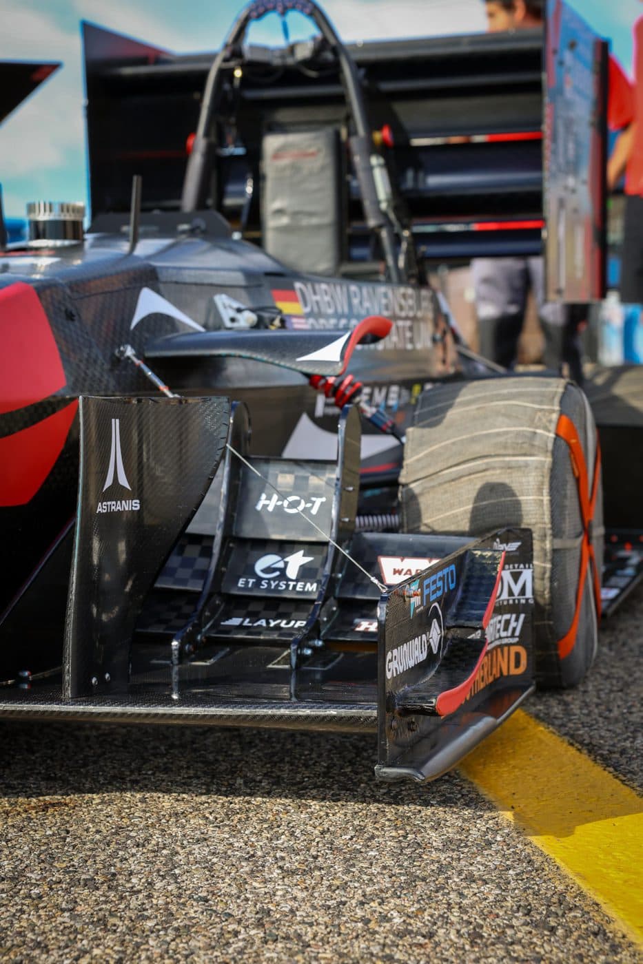 Front wing and endplate detail, with the outboard suspension visible behind it.
