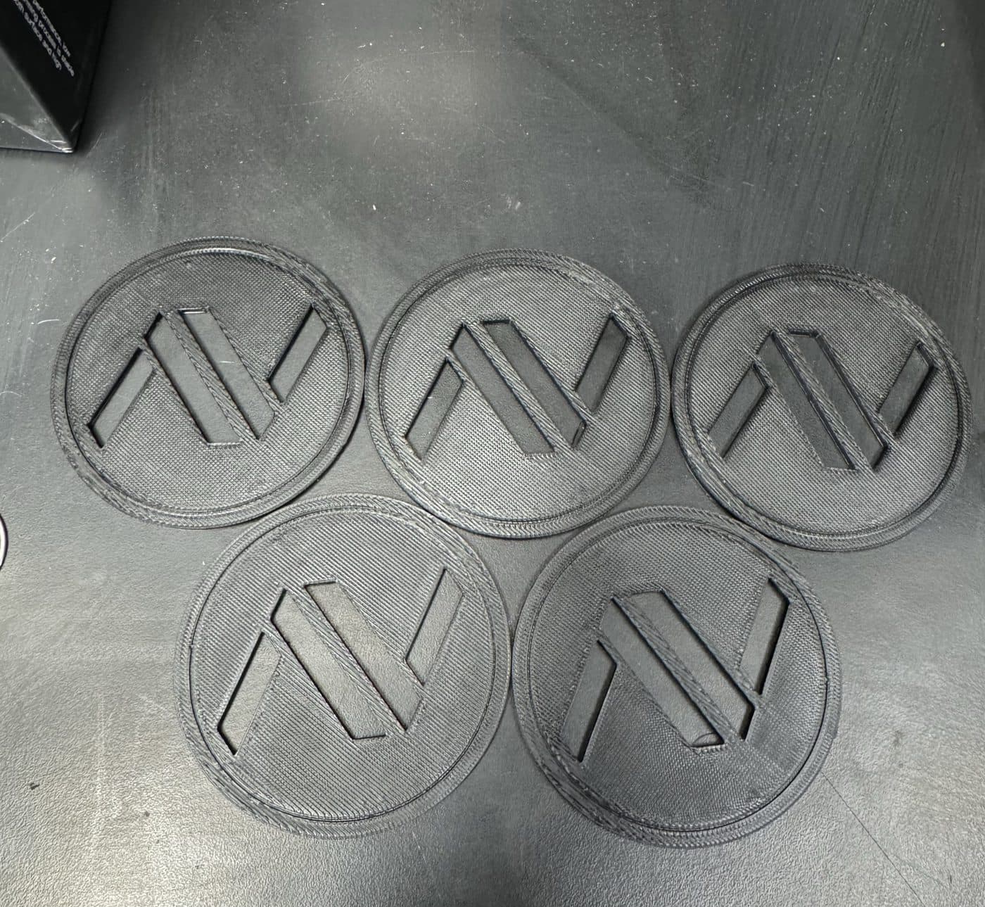 Navier company coasters modelled in Onshape and 3D printed, given to Navier's first customer.
