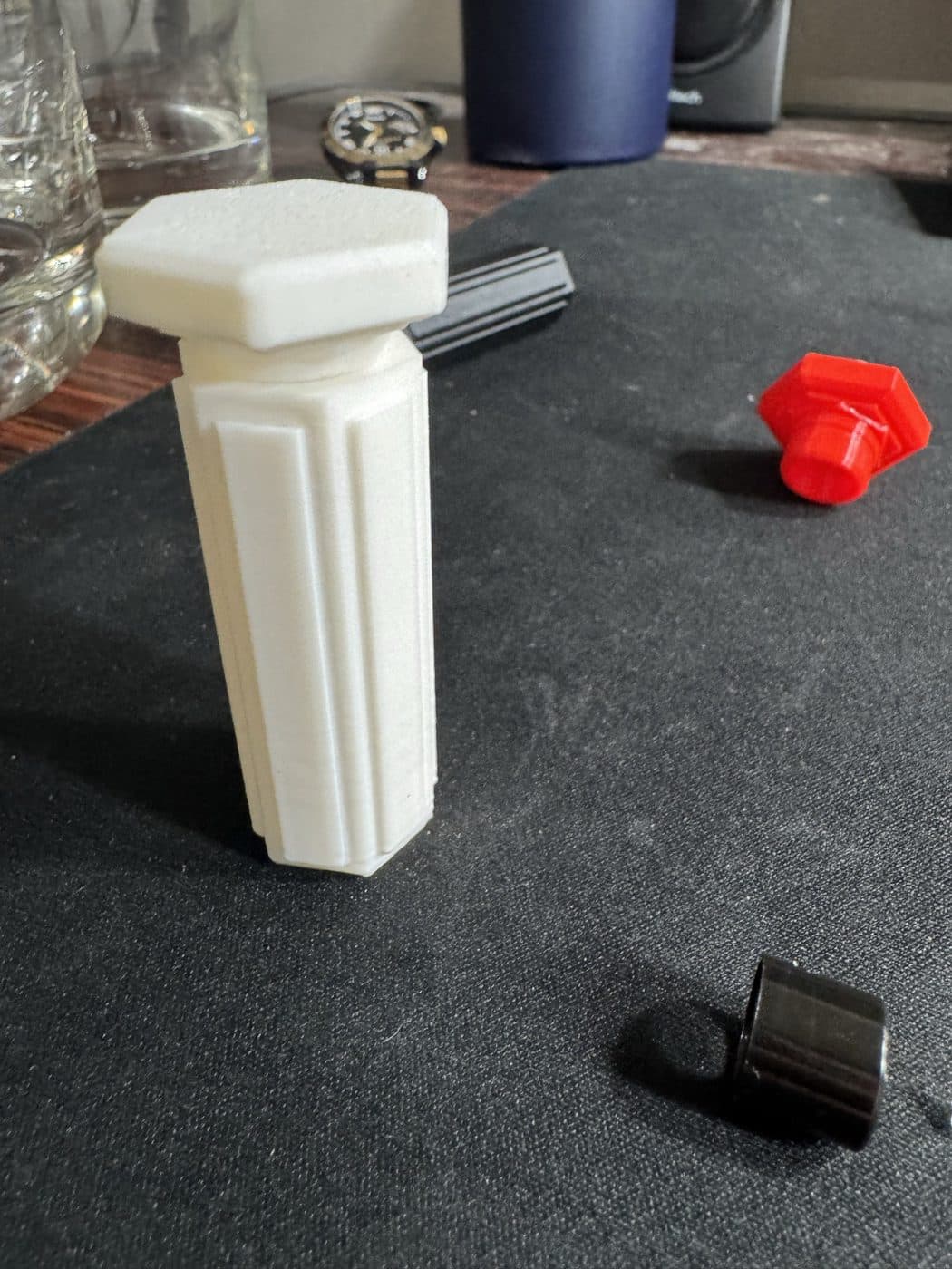 Printed case body with cap iterations in red and black beside it.