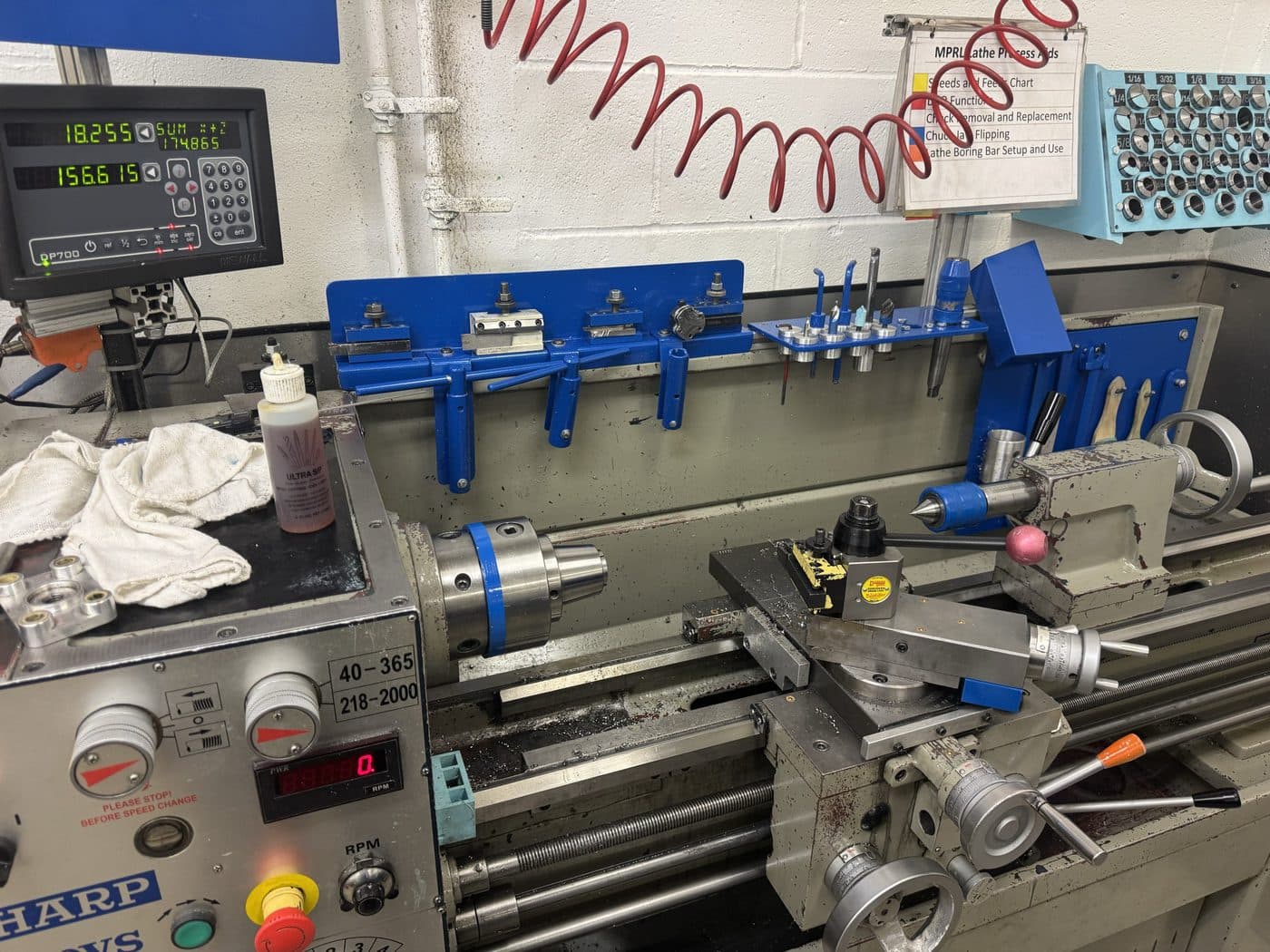 The Sharp manual lathe set up with the DRO live and boring bars racked behind.