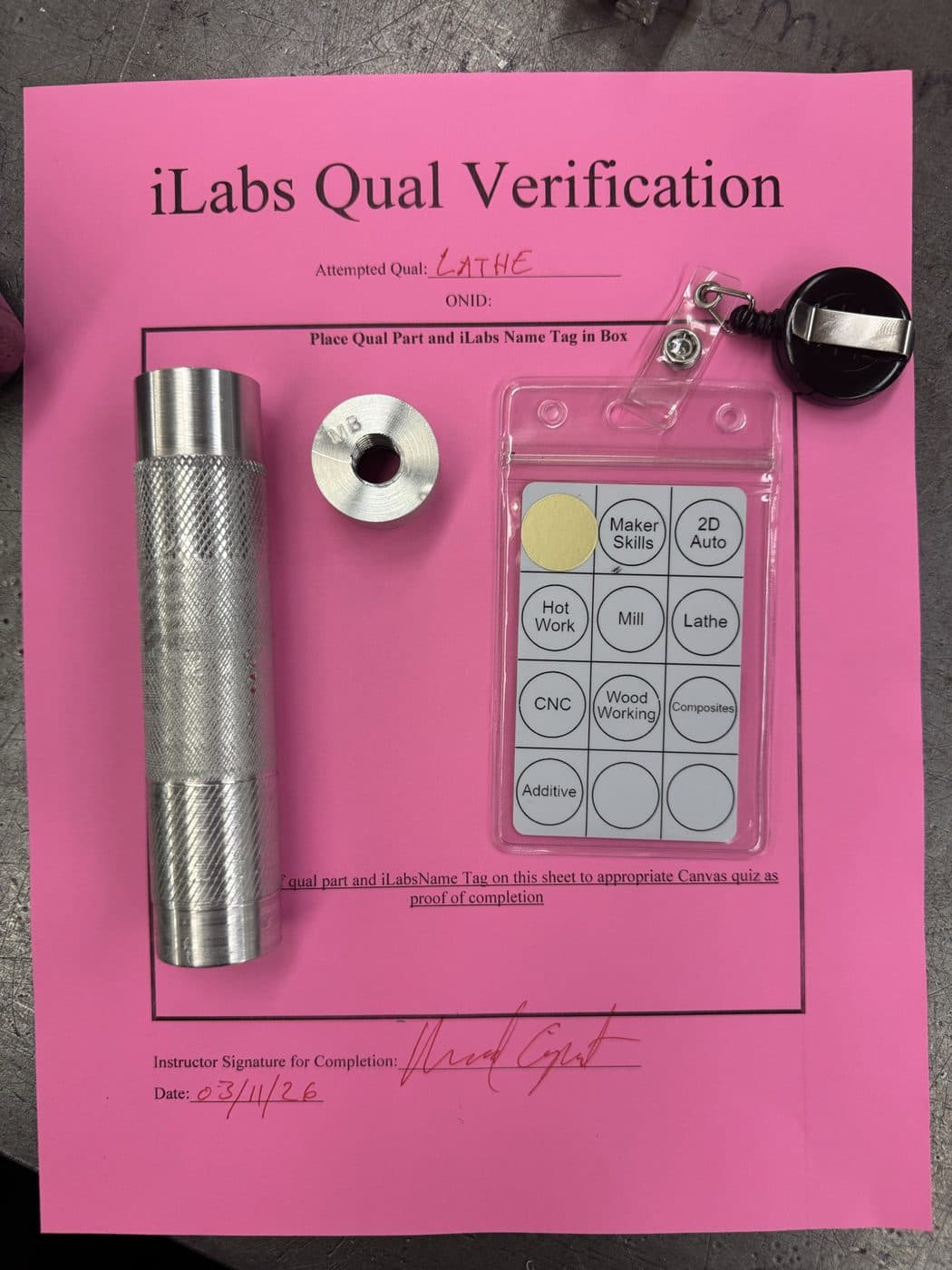 Signed iLabs lathe qualification sheet with a knurled handle and a turned, bored collar.